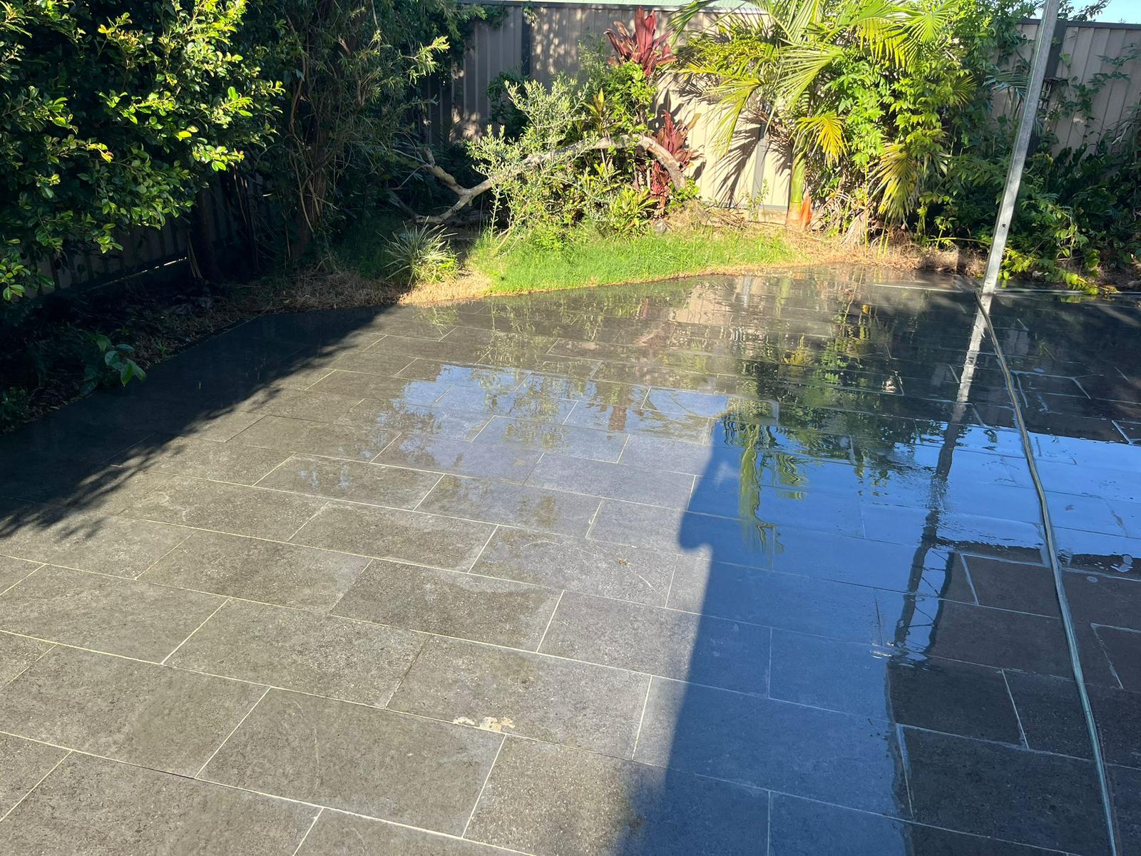 Freshly pressure-washed outdoor courtyard tiles in a Brisbane rental